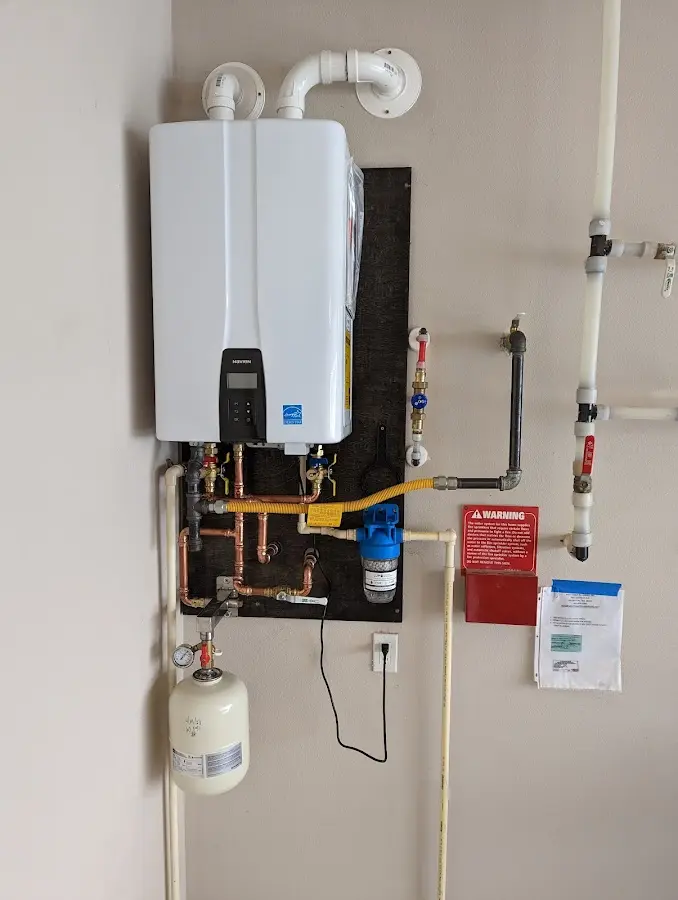 Professional plumber installing copper piping in a North Lakes home